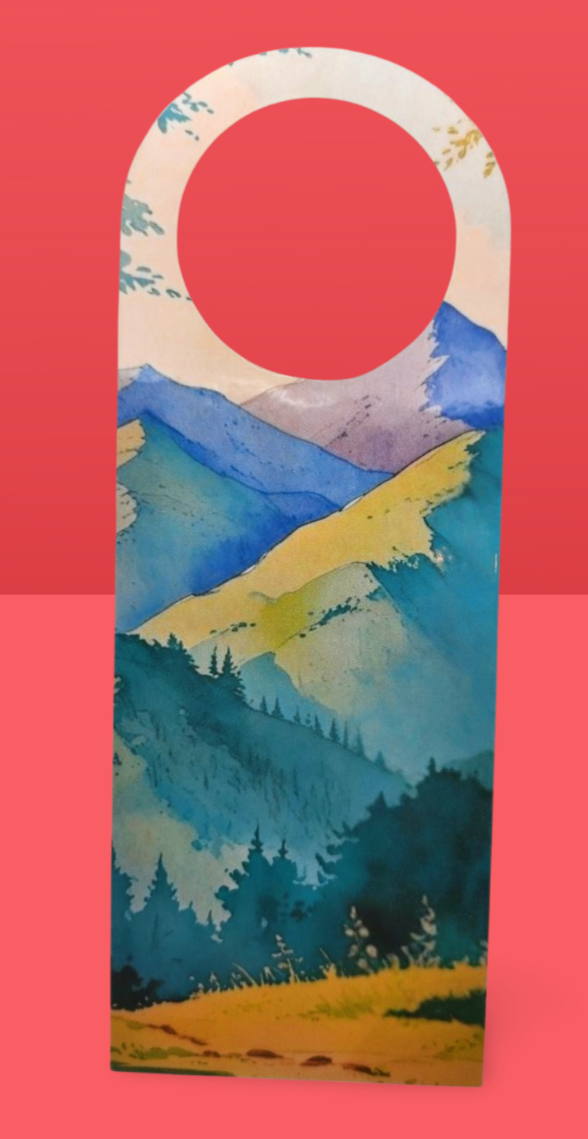 Decorative door hanger with a mountain landscape design on a red background