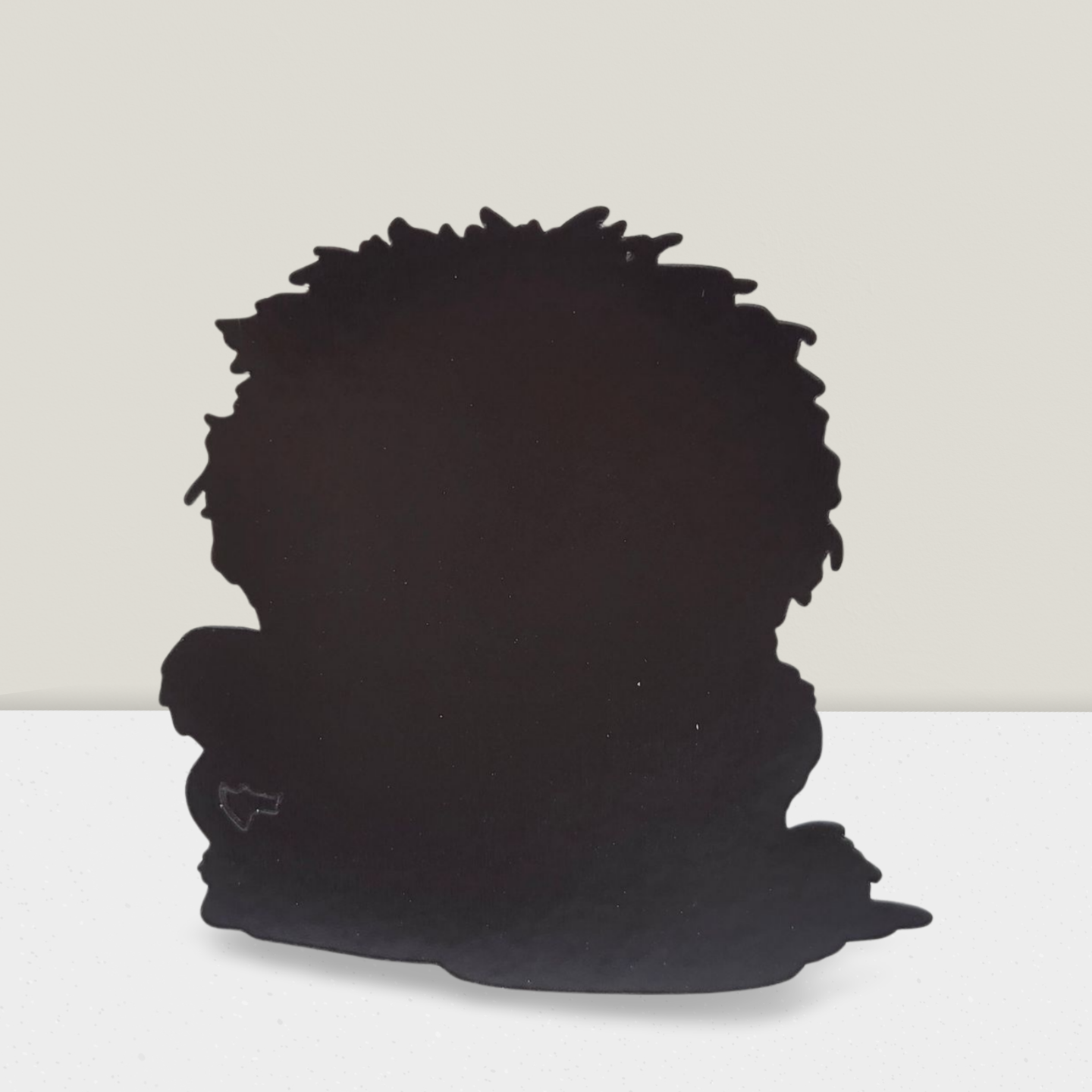 Black silhouette of a person with a large afro on a white background