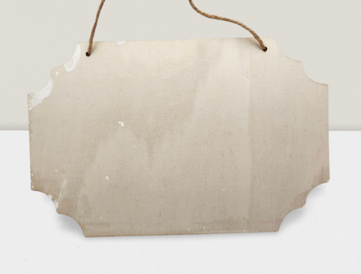Blank wooden sign with a string for hanging on a white background