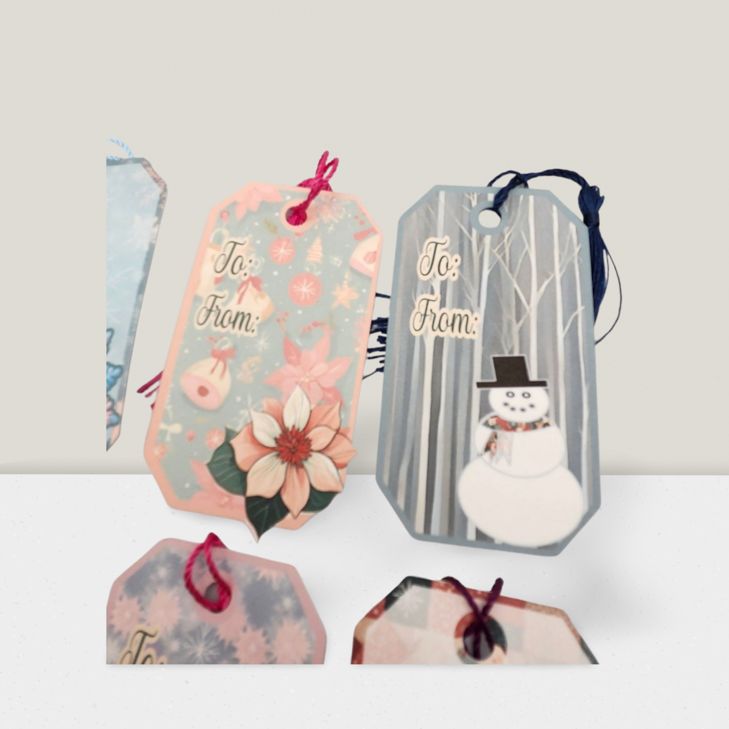 Set of decorative gift tags with floral and snowman designs on a white background