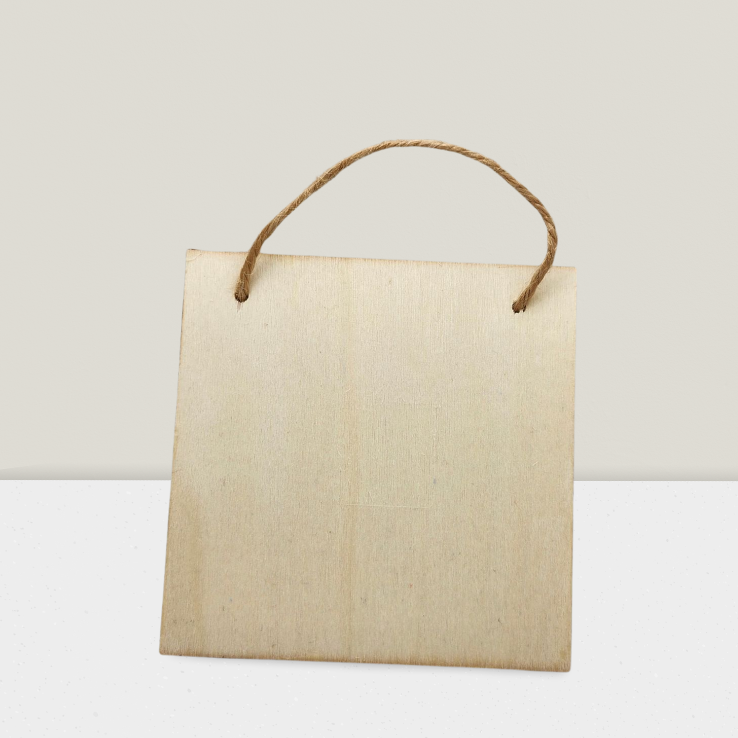 Beige paper bag with a rope handle on a light gray background