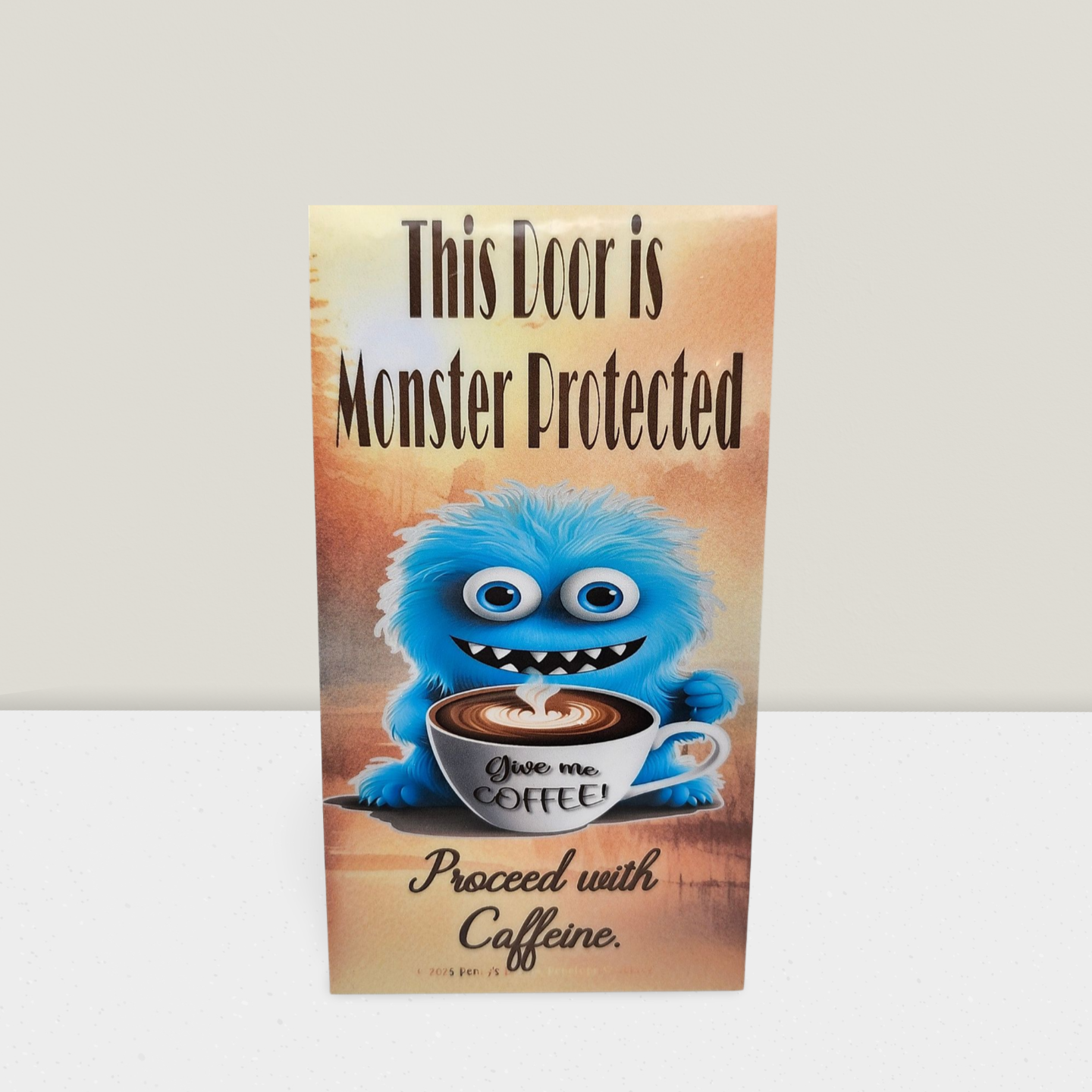 Door sign with a cartoon monster holding a coffee cup and text 'This Door is Monster Protected. Proceed with Caffeine.'