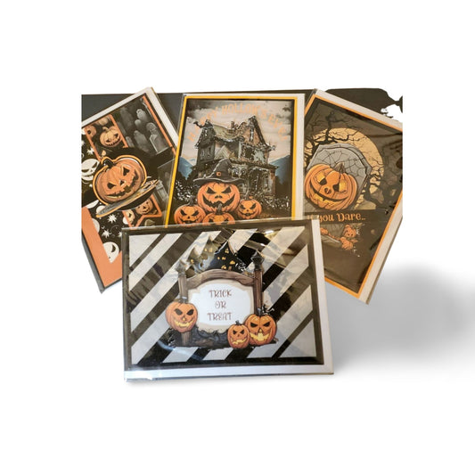 Halloween-themed greeting cards with pumpkins and haunted house designs on a white background.