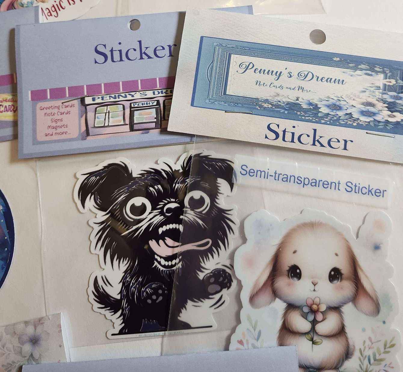 Collection of stickers including a black dog and a rabbit with text on the packaging.