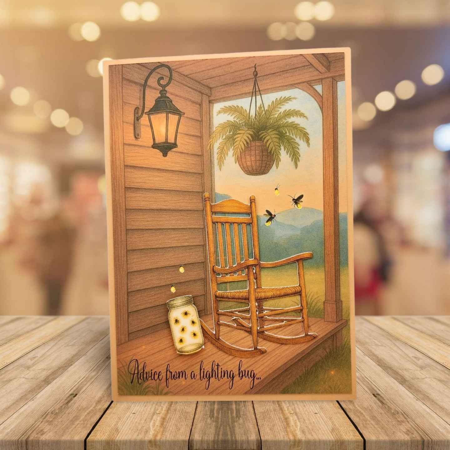 Decorative card with a rocking chair on a porch scene, placed on a wooden surface.
