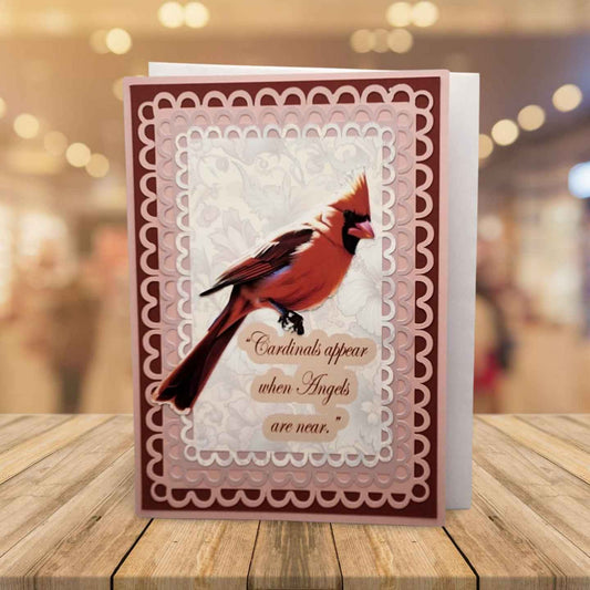 Card with a cardinal bird design on a wooden surface