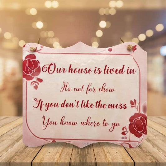 Decorative sign with a quote on a wooden surface with a blurred background