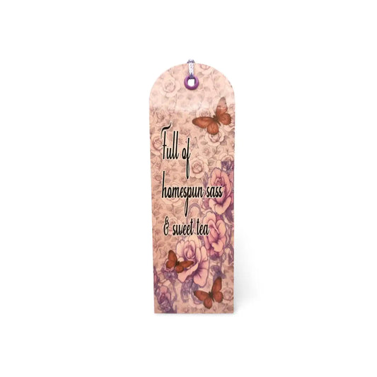 Decorative bookmark with floral design and text on a white background