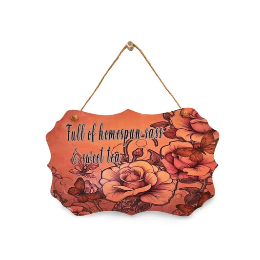 Decorative sign with floral design and text on a white background