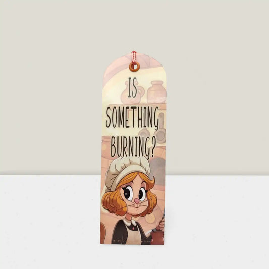 Bookmark with cartoon character and text 'Is something burning?' on a light gray background