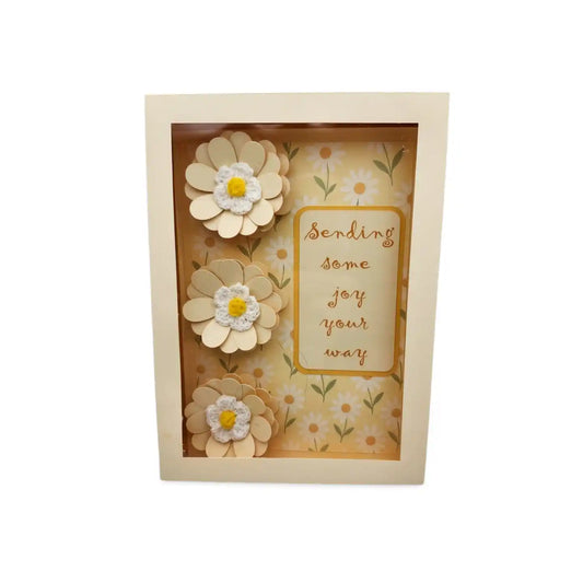 Decorative box with floral design and text 'Sending some joy your way' on a white background