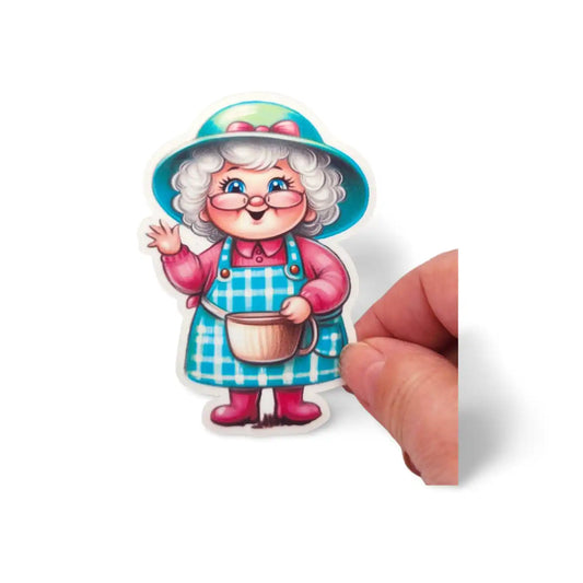 Cartoon character sticker of a woman with a blue hat and apron, held by a hand on a white background.