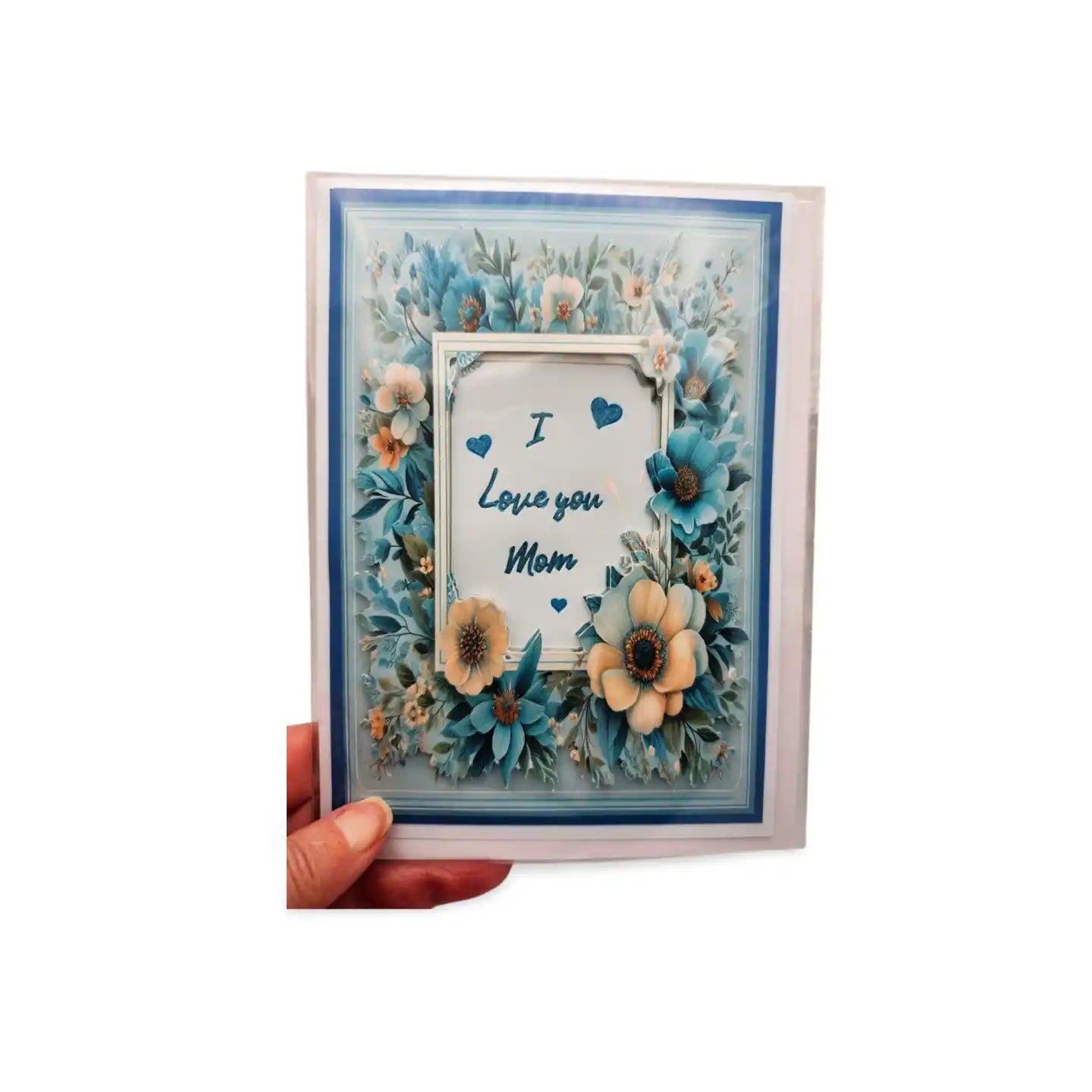 Greeting card with floral design and 'I Love you Mom' text held by a hand on a white background