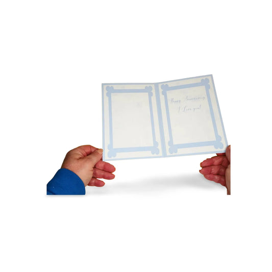 Person holding a folded card with blue border and text on a white background