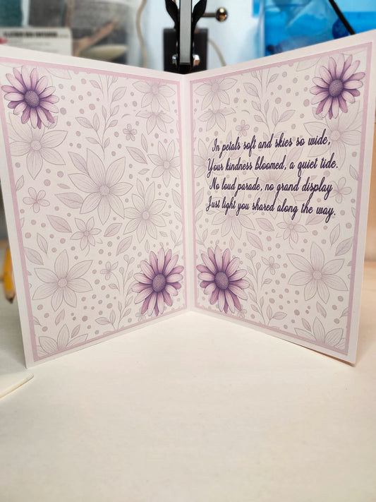 Greeting card with floral design and text on a white surface