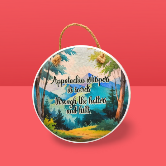 Round wooden sign with a scenic design and text on a red background