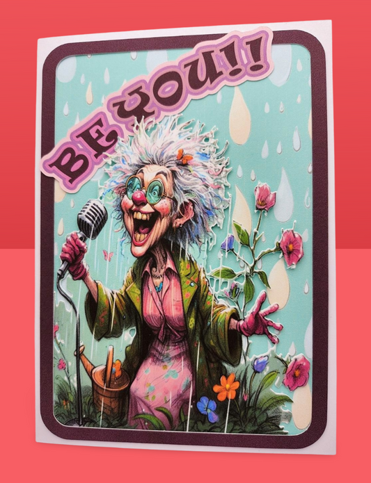 Cartoon character with a microphone and flowers, with text 'BE YOU!!' on a colorful background.