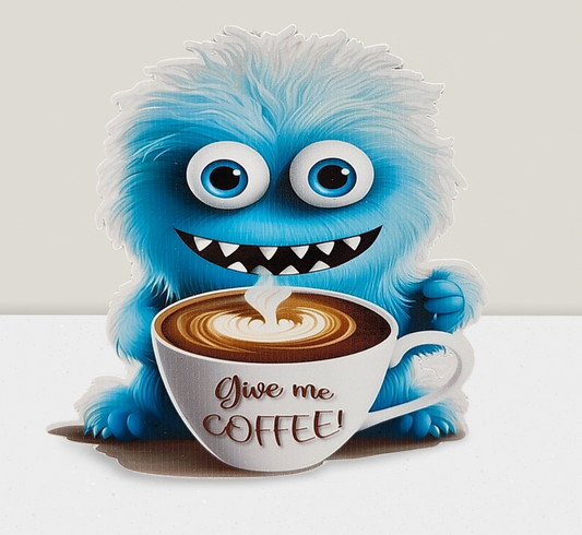 Blue monster holding a coffee cup with 'Give me Coffee!' text on a white background