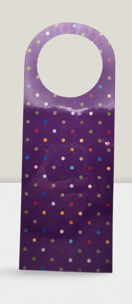 Purple door hanger with colorful polka dots on a white background