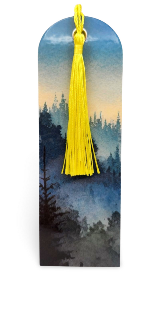 Bookmark with a yellow tassel against a scenic background