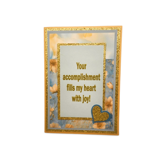 Greeting card with gold frame and text 'Your accomplishment fills my heart with joy!' on a white background