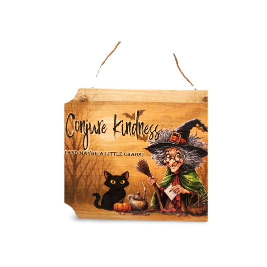 Wooden Halloween sign with witch and black cat design, featuring the text 'Conjure Kindness (and maybe a little chaos)'.
