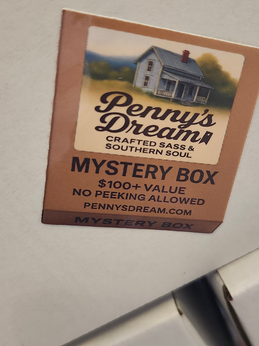 Penny's Dream mystery box packaging with a house illustration on a neutral background