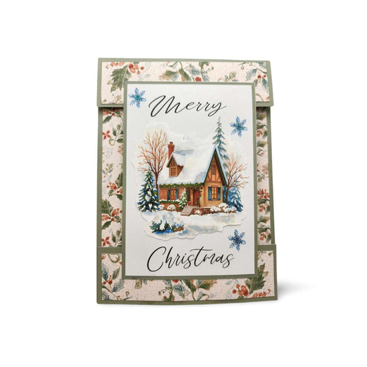 Christmas card with a snowy cabin illustration and floral border on a white background