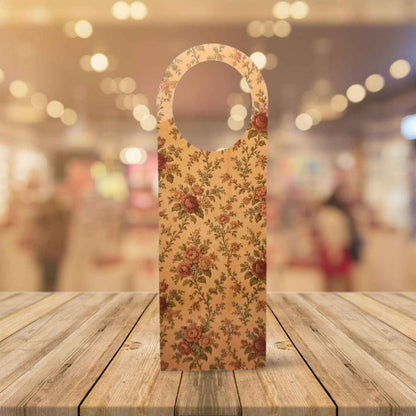 Floral-patterned bottle holder on a wooden surface with a blurred background