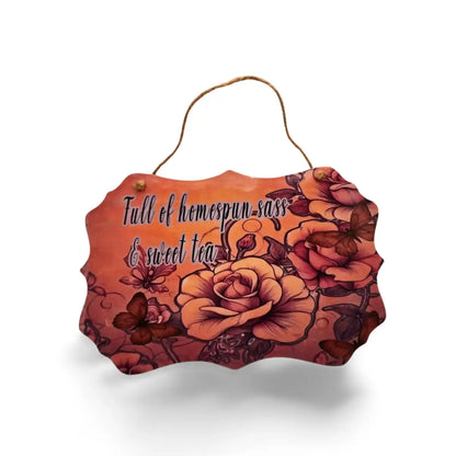 Decorative sign with floral design and text on a white background