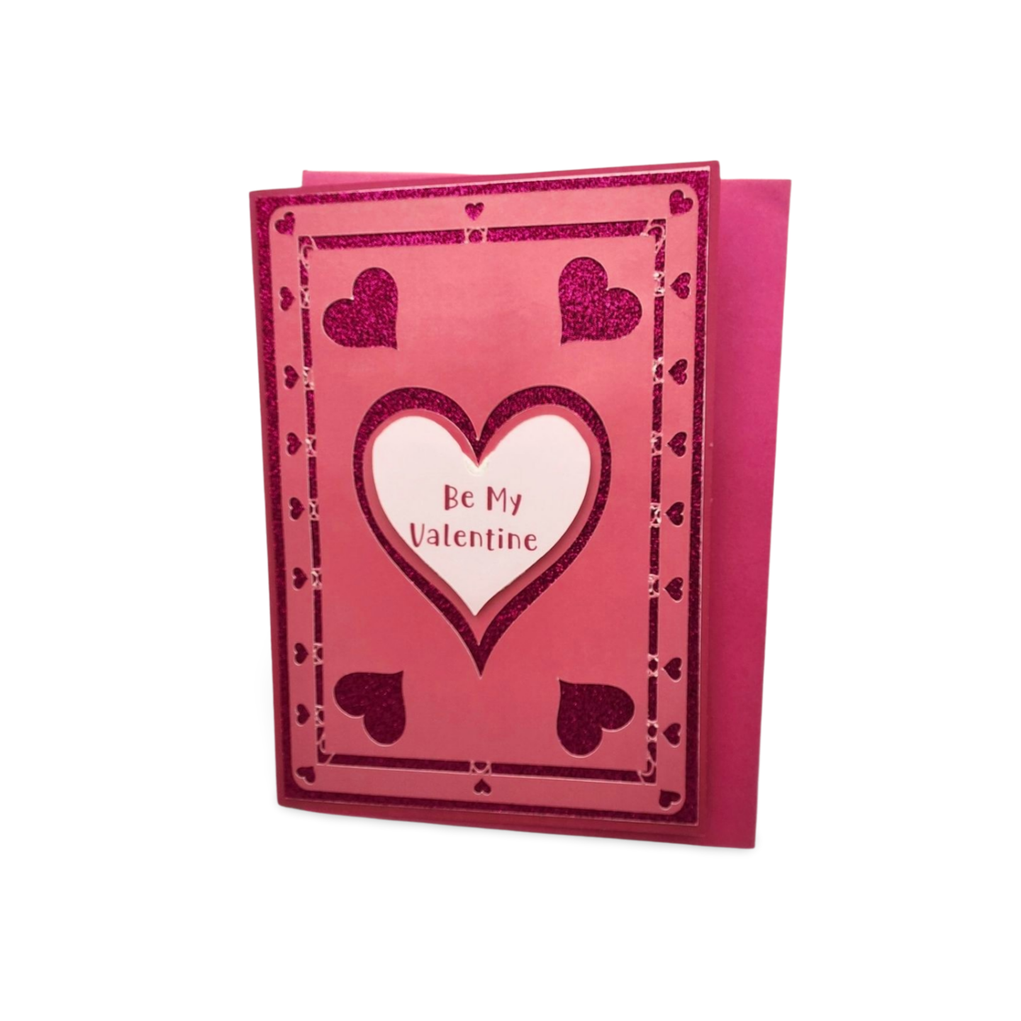 Pink Valentine's Day card with heart design and 'Be My Valentine' text on a white background