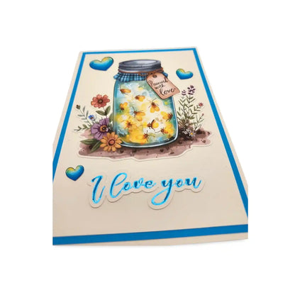 Card with a mason jar of flowers, decorative elements, and 'I love you' text on a white background.