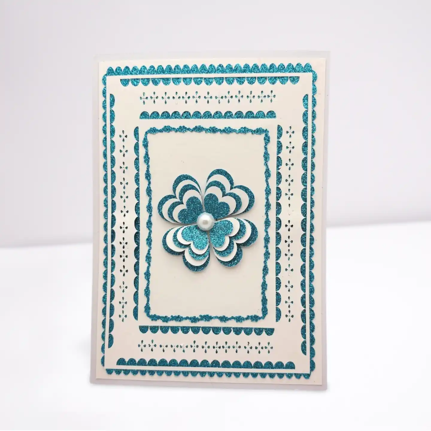 Card with decorative flower and pearl on a white background