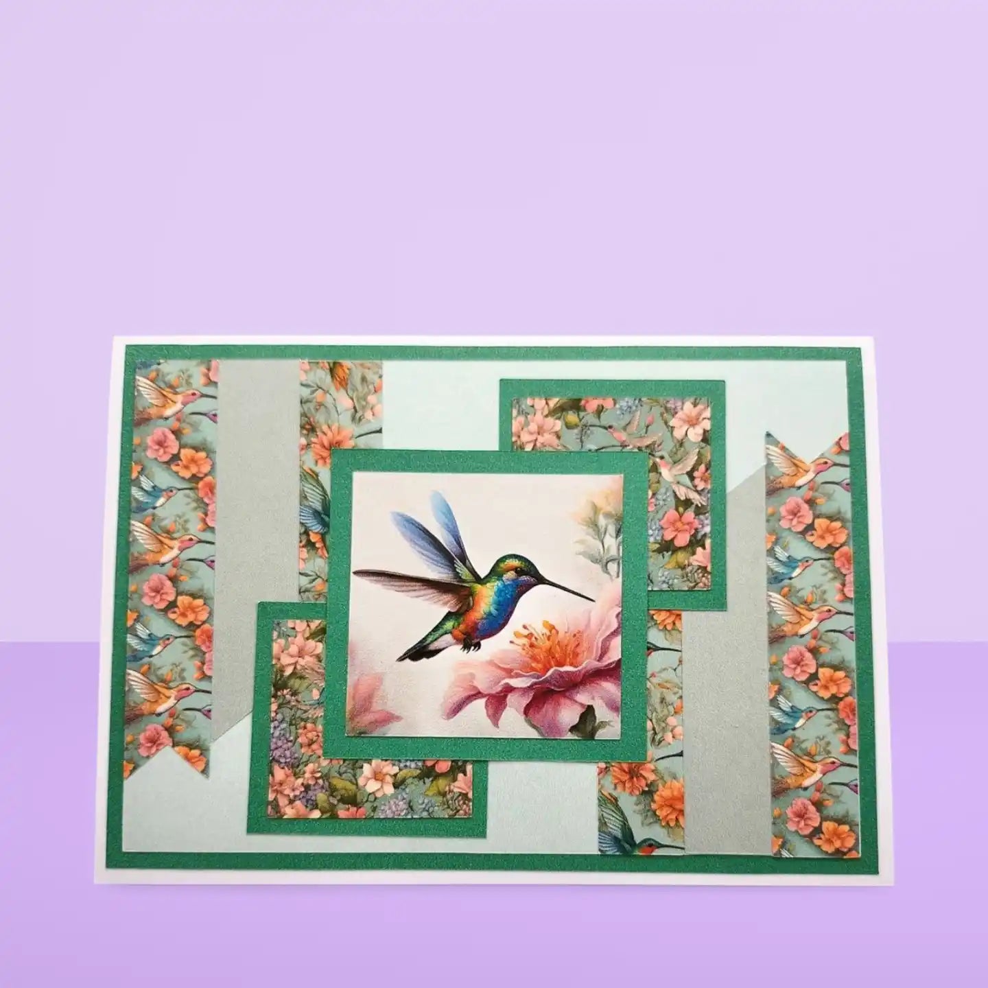 Decorative card with a hummingbird and floral design on a purple background