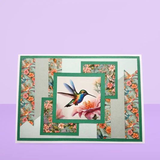 Decorative card with a hummingbird and floral design on a purple background
