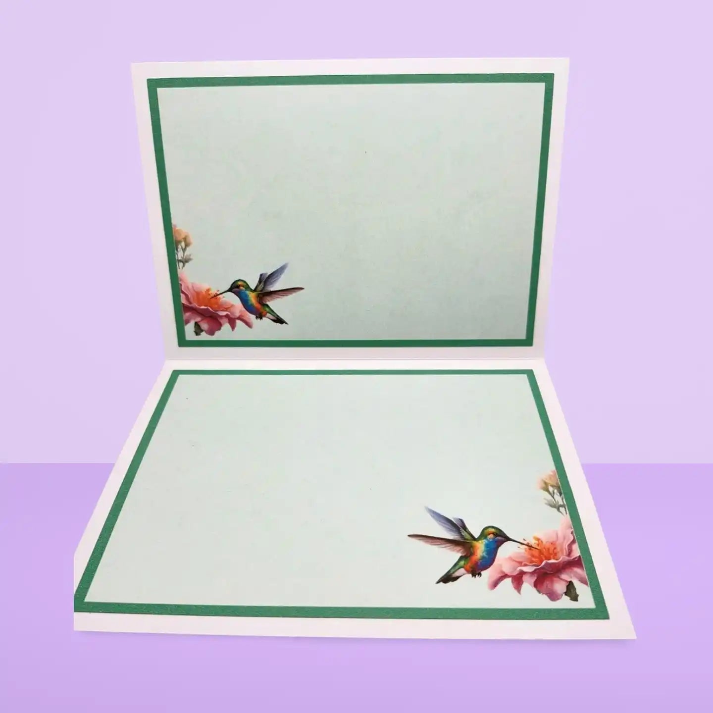 Open card with hummingbird and floral design on a purple background