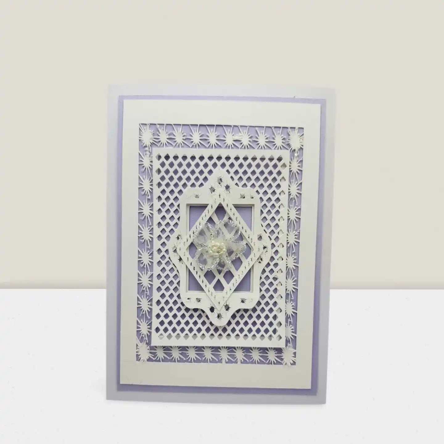 Decorative card with intricate cut-out design on a white background