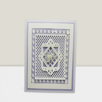 Decorative card with intricate cut-out design on a white background
