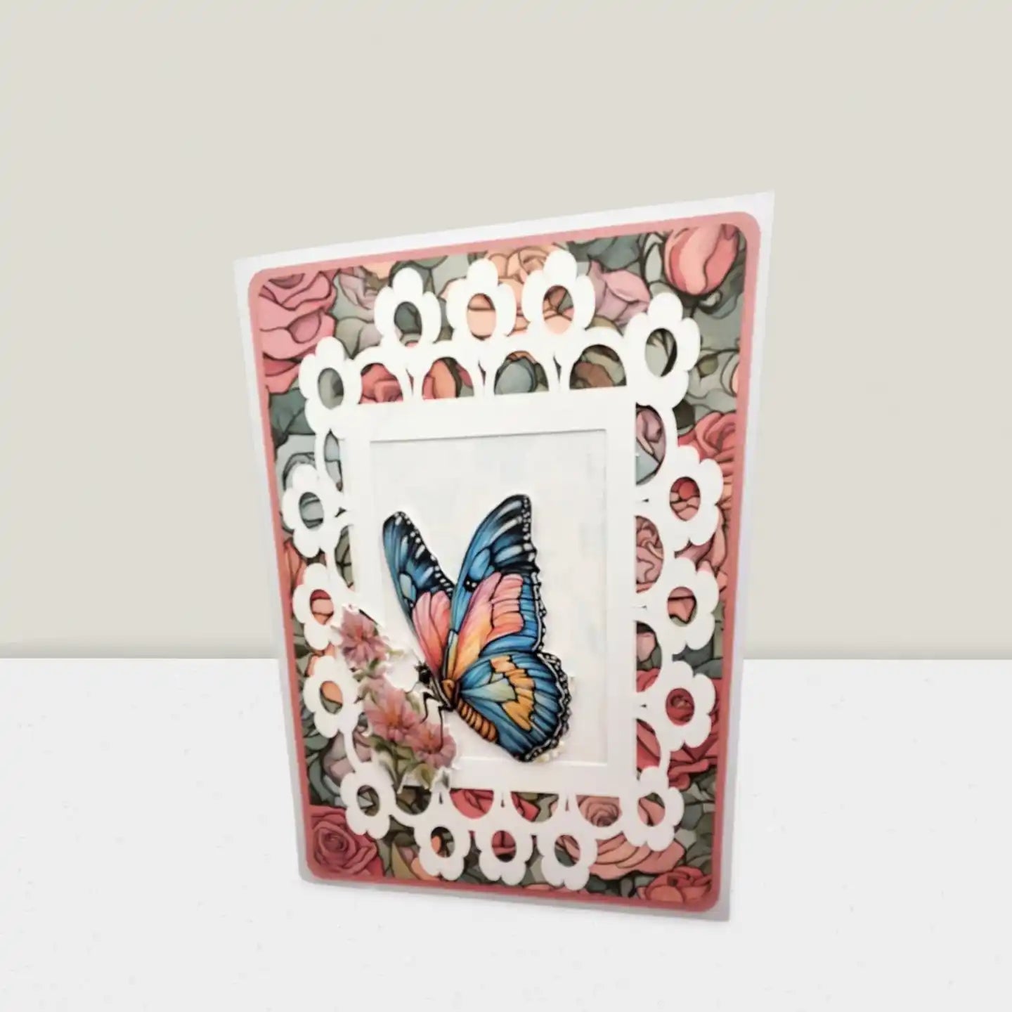 Card with decorative lace border and butterfly illustration on a floral background