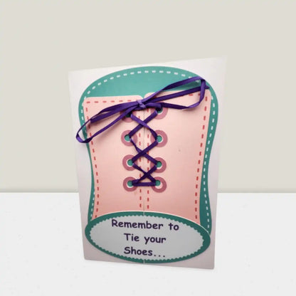 Card shaped like a shoe with laces and text 'Remember to Tie your Shoes' on a white background