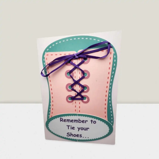 Card shaped like a shoe with laces and text 'Remember to Tie your Shoes' on a white background