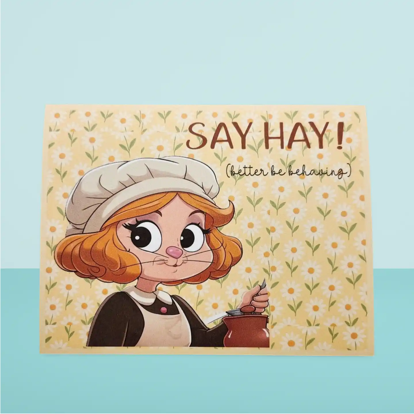 Cartoon character with a teapot on a floral background with text 'Say Hay! (better be behaving)'
