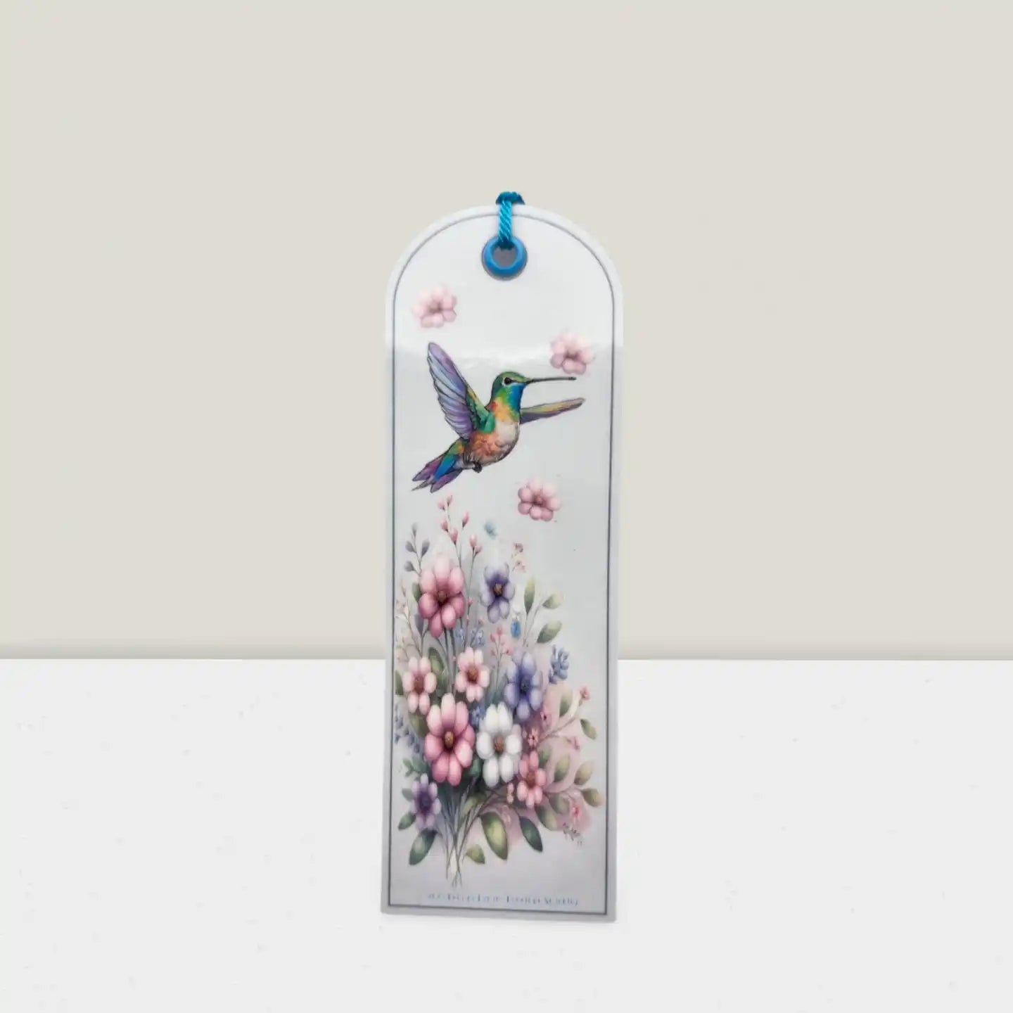 Decorative bookmark with a hummingbird and flowers on a white background