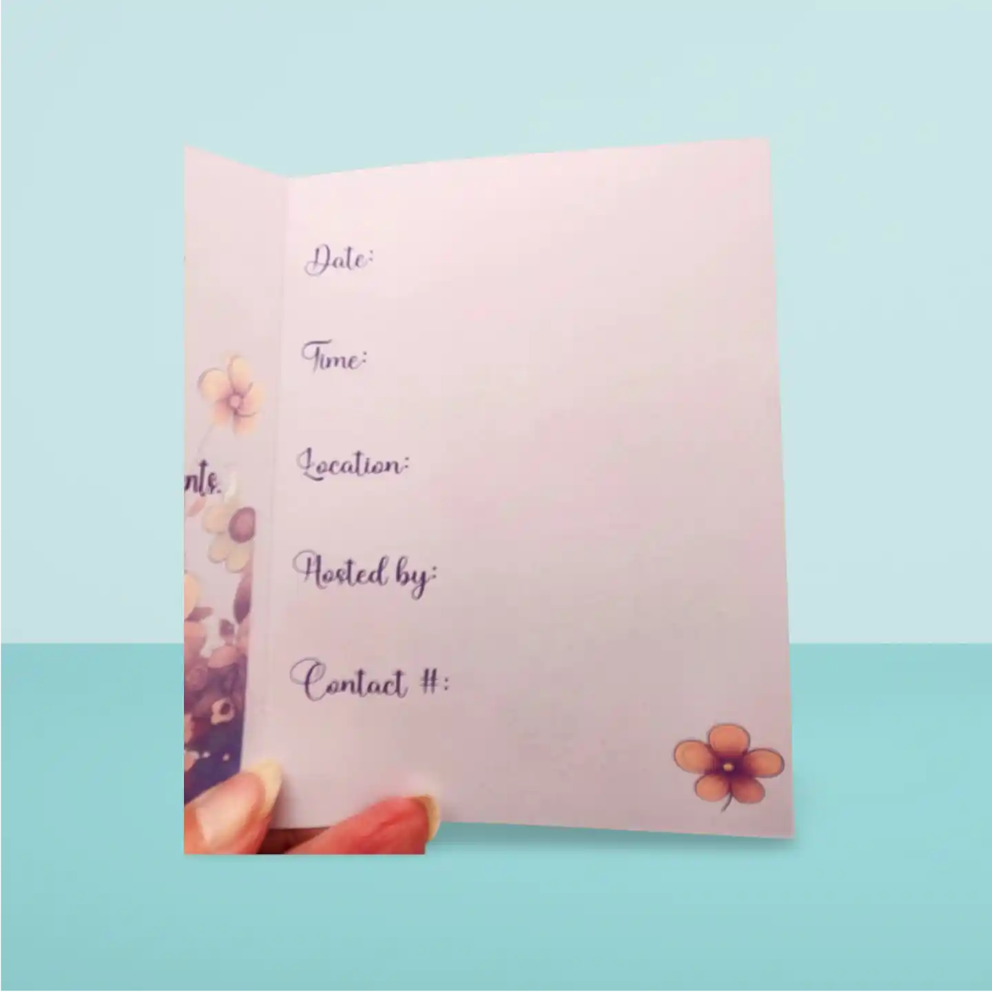 Pink invitation card with floral designs on a light blue background