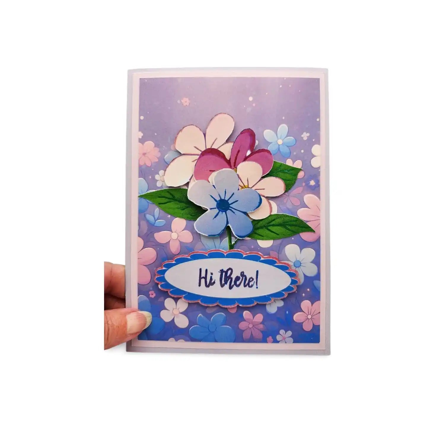 Colorful floral greeting card with 'Hi There!' text held by a hand on a white background