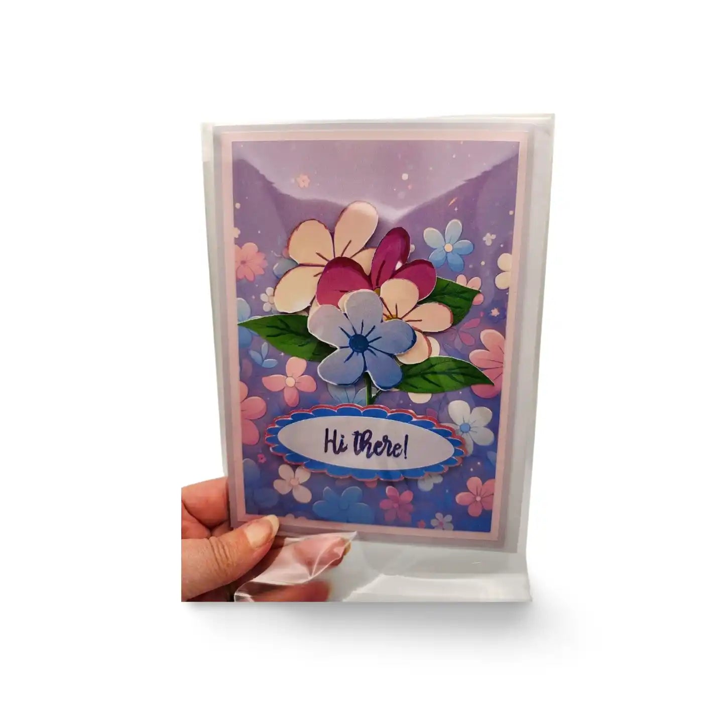 Floral greeting card with 'Hi there!' text held by a hand on a white background