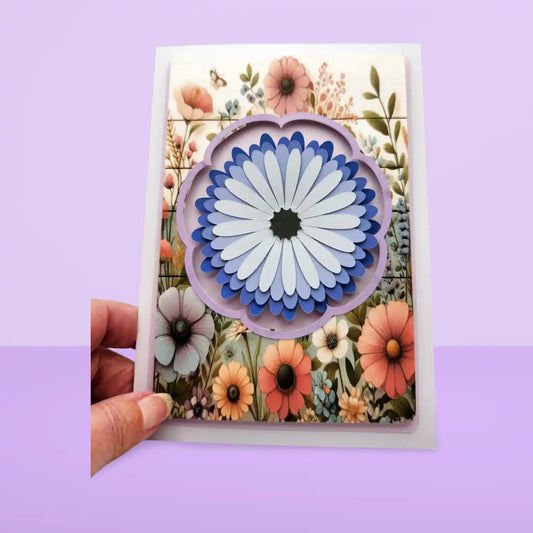 Card with a 3D flower design held against a purple background