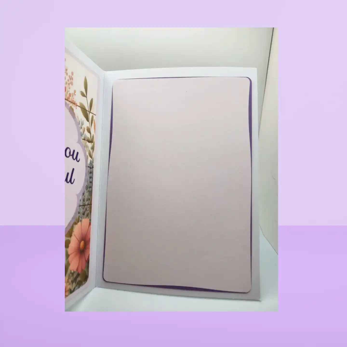 Open card with a floral design on a light purple background
