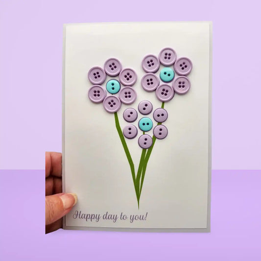 Card with button flowers and 'Happy day to you!' text on a purple background