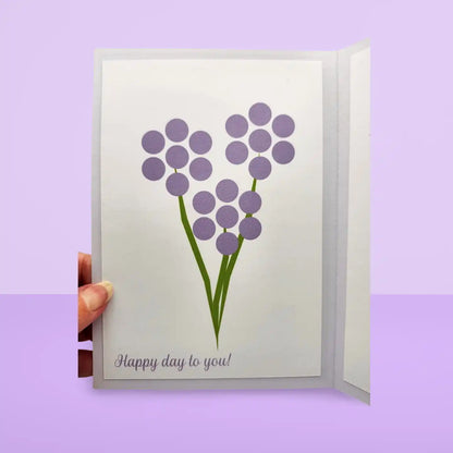 Greeting card with purple flowers and 'Happy day to you!' text on a light purple background